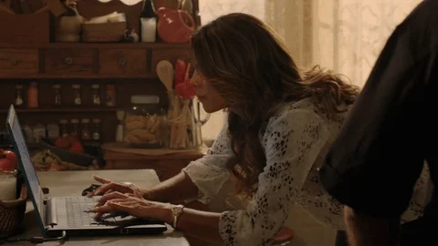 A woman typing and researching on her laptop
