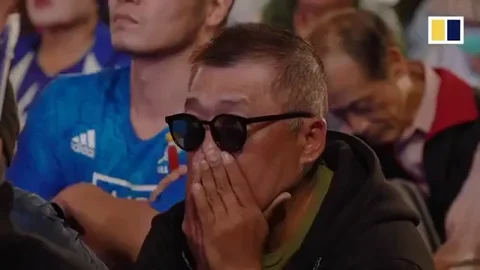 A man anxiously awaiting for the results of a sporting match.