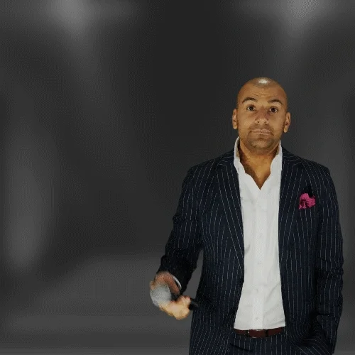 Person pointing a microphone outward saying, "It's your turn!"