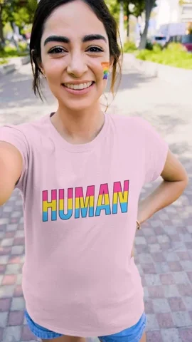  A person wears a pink t-shirt that says 