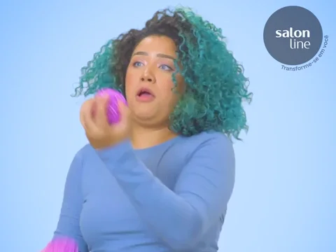 A person's unsuccessful attempt at juggling three purple balls.