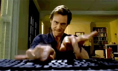 Jim Carrey frantically typing on his keyboard.