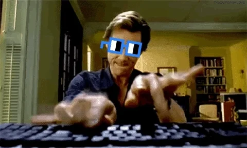 Jim Carrey typing on a keyboard with sunglasses on.