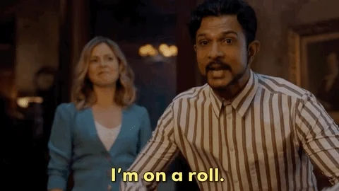 Excited man says, "I'm on a roll." with a supportive person standing behind him, looking happy.