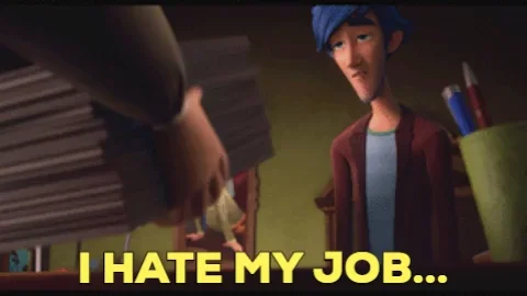 A short man wearing glasses is piling papers onto a table. He is shouting and pointing at a taller man with blue hair.