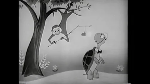 An old cartoon of a monkey trying to drop dynamite on a turtle from a tree. The tree explodes and kills both animals.