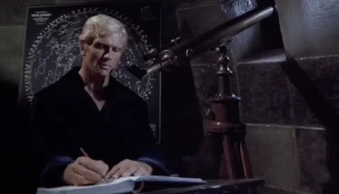 GIF of man writing in a book.