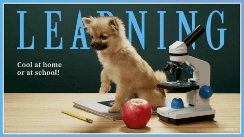 A dog waving beside a microscope. The text reads, 