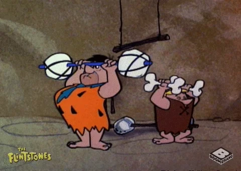 Animated characters from The Flintstones lifting stone barbells, symbolizing building strength through practice and effort.