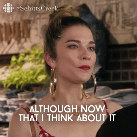 Alexis Rose from Schitt's Creek says, “Although now that I think about it..." to a salesperson in a clothing store.
