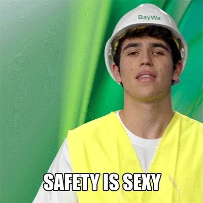 A young man puts on a hard hat and safety glasses. The text reads, 'Safety is sexy.'