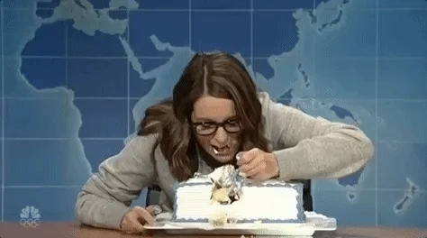 Tina Fey, a star of Saturday Night Live, is stress-eating an entire cake. 