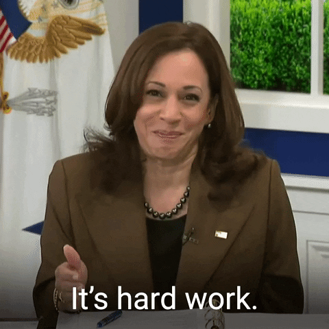 Kamala Harris seated at a desk saying, 'It's hard work'.