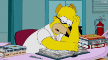Homer Simpson studying and looking stressed