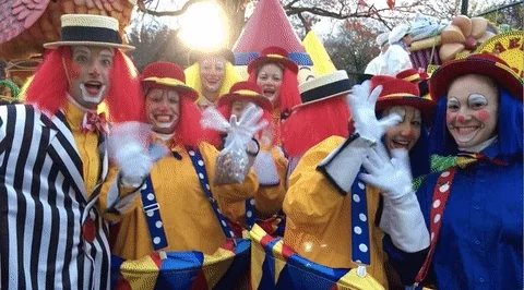 A group of clowns waving.