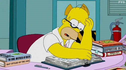 A stressed Homer Simpsons flicking through pages, surrounded by books. 