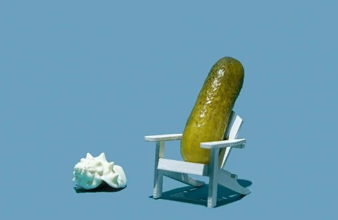 A calm cucumber wearing sunglasses, sitting in a deck chair.