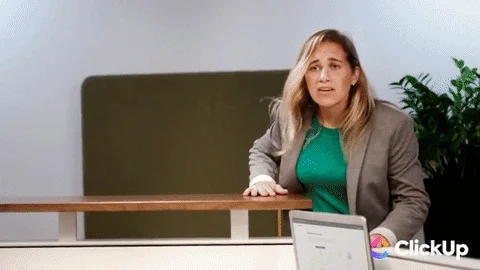 A man typing furiously on a keyboard while his coworkers asks a panicked question.