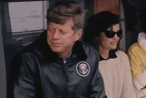John F Kennedy on a boat, accompanied by Jaqueline Kennedy.
