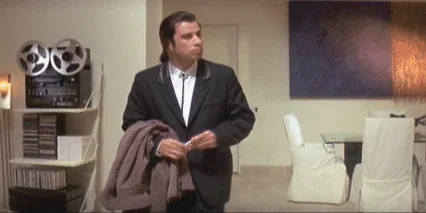 Vincent Vega from Pulp Fiction looking lost in a house.