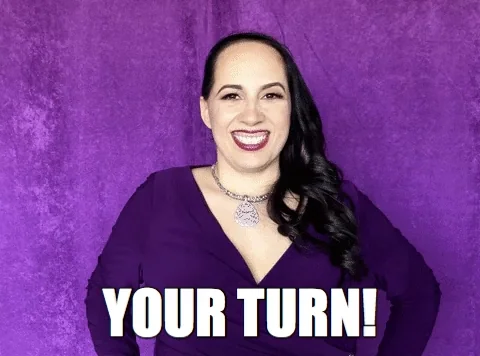 A woman smiling and pointing. The text reads, "Your turn!"