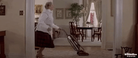 Woman dancing while vacuuming 