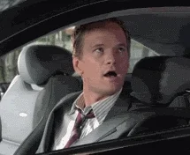 Barney from How I Met Your Mother sits in a car and gives both thumbs up.
