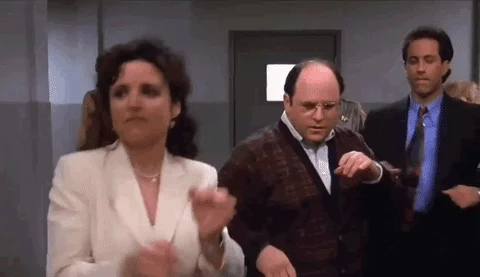 George Costanza, Elaine, and Jerry from the TV show Seinfeld dancing.