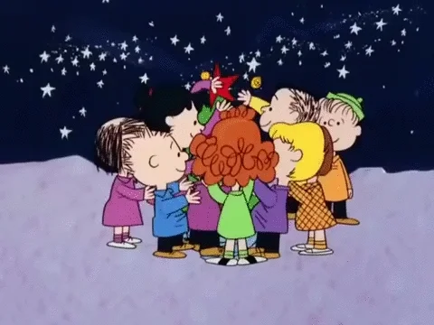 The Peanuts crew gathering around a Christmas tree