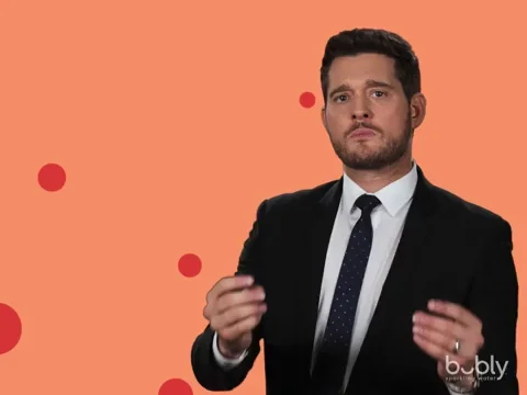 Michael Bublé confidently pointing with text in the background stating 