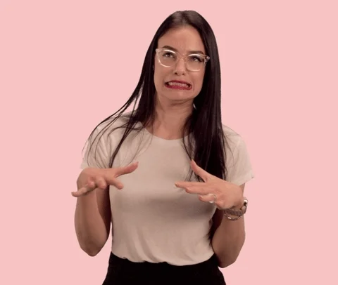 A woman grimaces over a difficult decision while gesturing back and forth with her hands.
