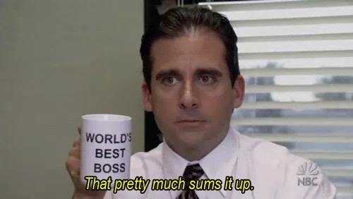 Michael from the office holds a mug that says 