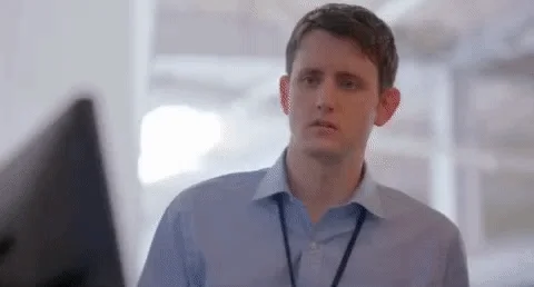 A software developer looks at a computer with confusion.