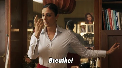 A woman in a home office taking deep breaths.