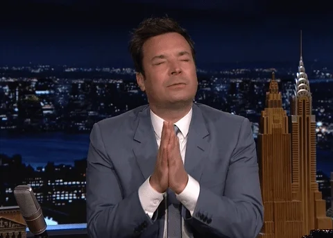 Jimmy Fallon praying with his eyes closed.