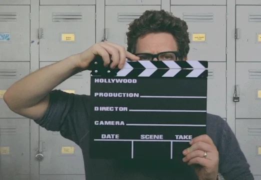 Director calling for action with his clapperboard.