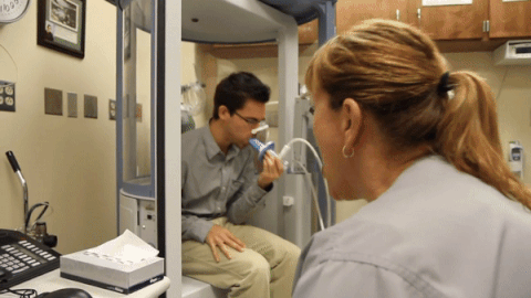 A Respiratory Therapist tests a man's lung capacity.