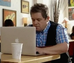 Comedian Patton Oswalt getting frustrated with his laptop