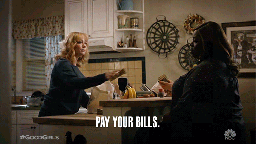 A woman putting cash on the table and telling her friend, 'Pay your bills.'