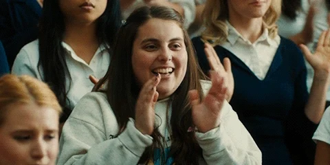 Girl clapping and giving thumbs up.