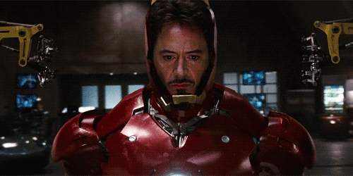 Iron Man in his armor suit. His helmet mask closes and the eyes light up.