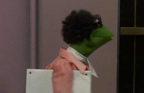 Kermit dressed in business attire. He is ready for a meeting.