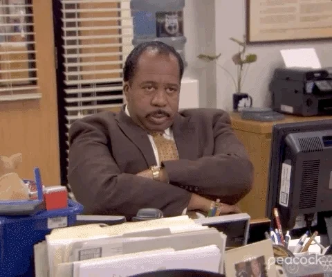 GIF of Stanley from the TV show The Office frowning with his arms crossed.