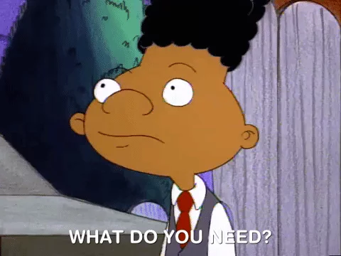 Gerald Johanssen from the cartoon Hey Arnold! wearing a suit and red tie, looking forward and saying, "What do you need?"