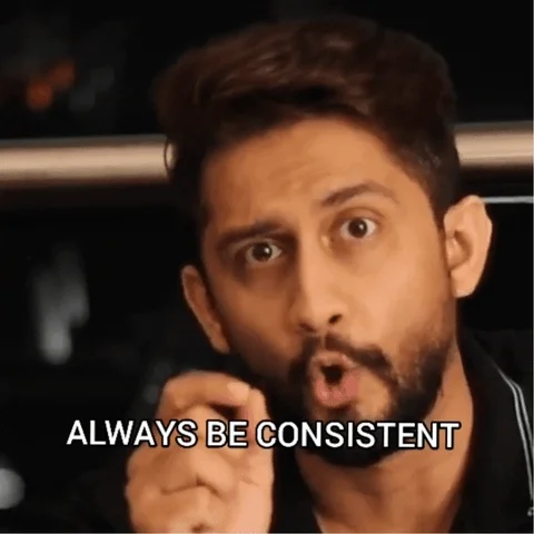 A South Asian man gestures and looks into the camera to make an important point, 