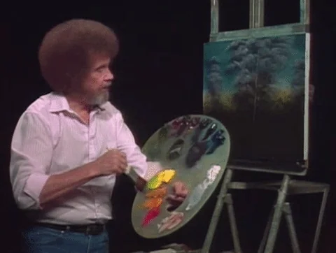 Bob Ross mixing paints on a palette.