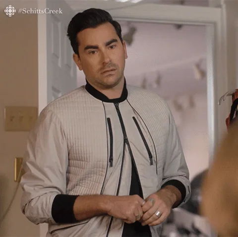 David Rose from Schitt's Creek having a fake excited reaction while saying, 