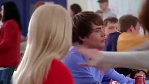A high school student watches as two classmates fight in a the school cafeteria.