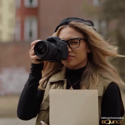 A young woman taking photos and thinking about who should have a career portfolio and how often should it be updated.