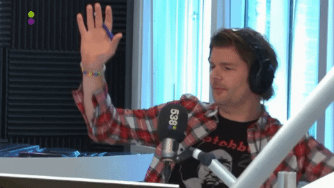 A radio DJ dancing in the studio